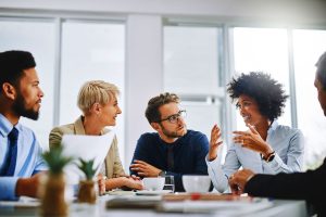 Diverse business team engaged in discussion during office meeting