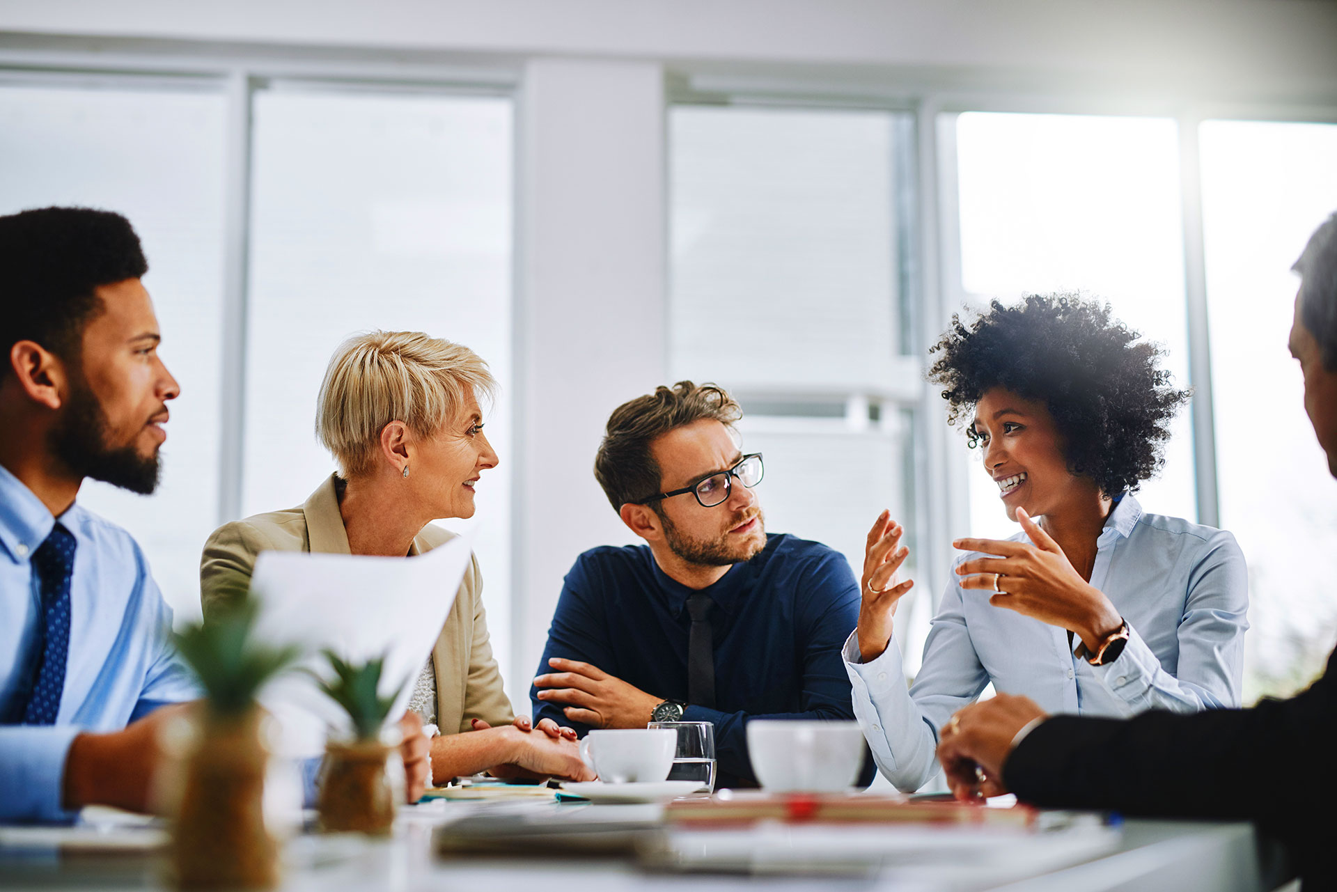 Diverse business team engaged in discussion during office meeting